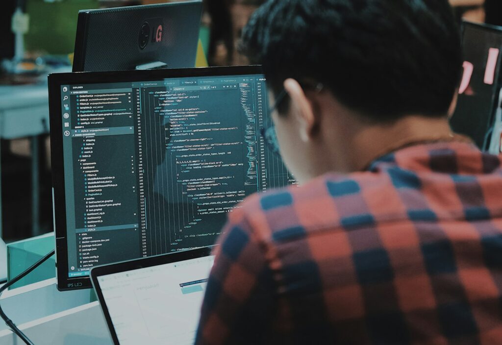 Engineer working at multiple monitors